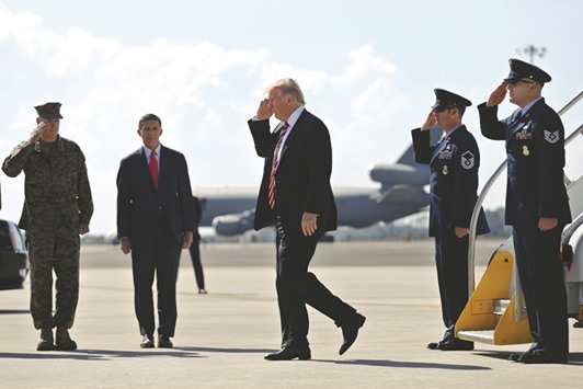 US President Donald Trump salutes as he arrives at MacDill Air Force Base in Tampa, Florida yesterday. World stock markets fell yesterday, pulled down by weaker prices on Wall Street as investors wait for new political developments in the US, traders said.