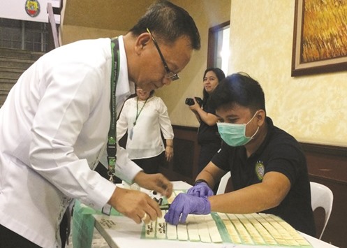 Philippine Drug Enforcement Agency (PDEA) Director General, Isidro Lapena, signs documents before taking a mandatory drugs test at the headquarters of PDEA in Quezon City yesterday.