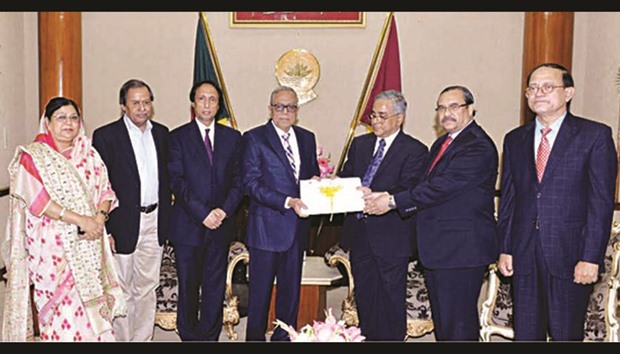 Supreme Court Judge Syed Mahmud Hossain handing over a list to President Abdul Hamid in Dhaka yesterday.
