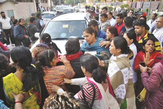 BJP workers stop the car of Delhi Deputy Chief Minister Manish Sisodia after he visited Asha Kiran Home for the mentally challenged in New Delhi yesterday.