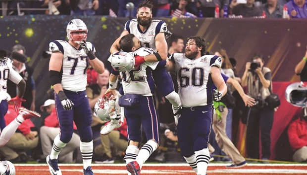 New England Patriots quarterback Tom Brady (12) and wide receiver Julian Edelman celebrate after winning Super Bowl at NRG Stadium in Houston on Sunday. (AFP)