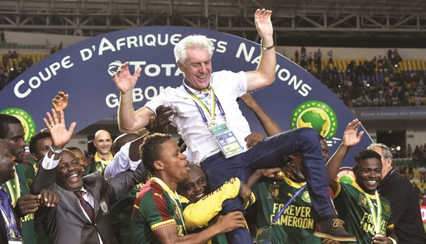 Cameroon players lift their Belgian coach Hugo Broos as they celebrate after beating Egypt 2-1 to win Africa Cup of Nations. (AFP)