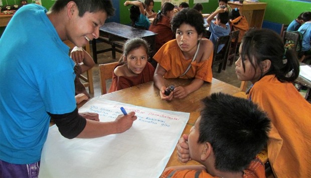 Amazonian children participating in activities designed to practice their native language