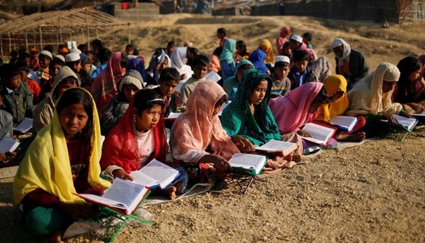 Rohingya refugee children attend an open air Arabic school