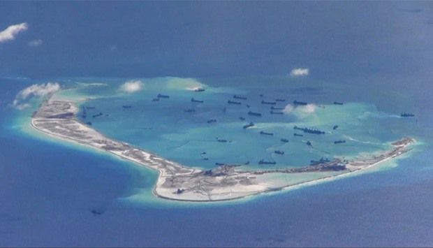 Chinese dredging vessels are purportedly seen in the waters around an Island in the South China Sea
