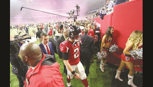 Atlanta Falcons quarterback Matt Ryan (right) leaves the field after being defeated by the New England Patriots 34-28 in overtime in Super Bowl at NRG Stadium in Houston, Texas, on Sunday. (USA TODAY Sports)