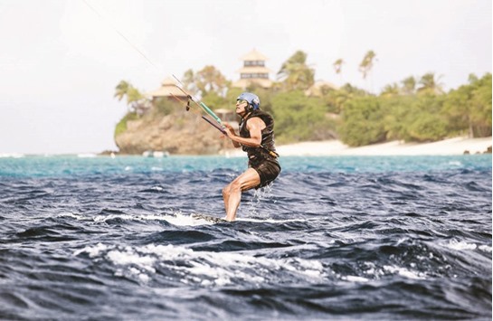 Obama tries his hand at kiteboarding during a holiday with Branson on Moskito island, in the British Virgin Islands, in a picture handed out by Virgin.