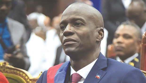 New Haitian President Jovenel Moise sits in the Haitian Parliament after receiving his sash during his formal inauguration in Port-au-Prince yesterday.