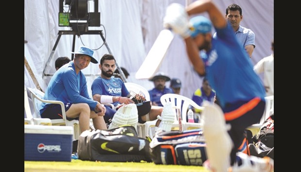 Indiau2019s cricket captain Virat Kohli (second left) and physio Patrick Farhart (left) look on as teammate Ajinkya Rahane bats in the nets during a practice session, on the eve of one-off Test against Bangladesh in Hyderabad, yesterday.