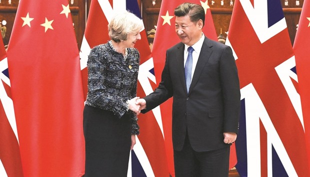 Chinese President Xi Jinping (right) shakes hand with British Prime Minister Theresa May on the sidelines of the G20 Summit last year.
