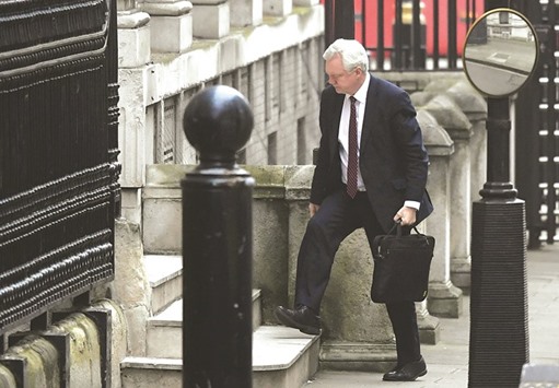 Britainu2019s Brexit Secretary David Davis walks into his office in Downing Street.