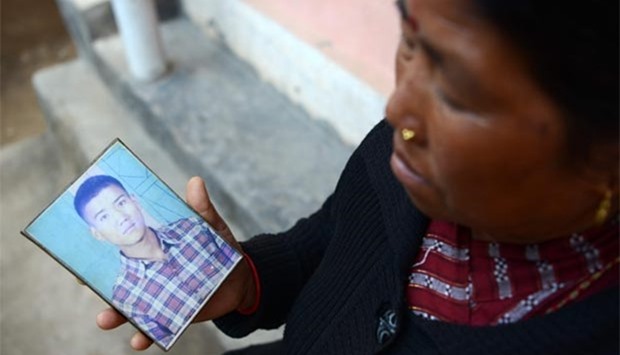 Nepalese war victim Pabitra Sunakhari shows a photograph of her son as she speaks in Birendranagar, some 520km west of Kathmandu.