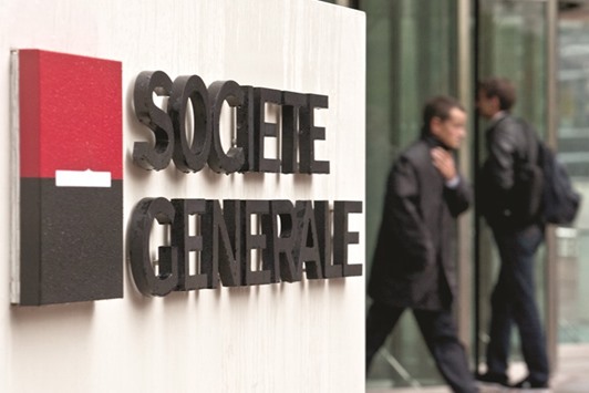 Visitors are seen at the entrance to the headquarters of Societe Generale in Paris. One of the top gainers in Paris was SocGen, whose shares won almost 3% after posting better-than-expected net profits for 2016.