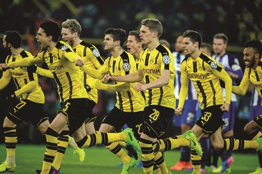 Borussia Dortmund players celebrate after the penalty shoot-out win over Hertha Berlin in German Cup on Wednesday. (AFP)