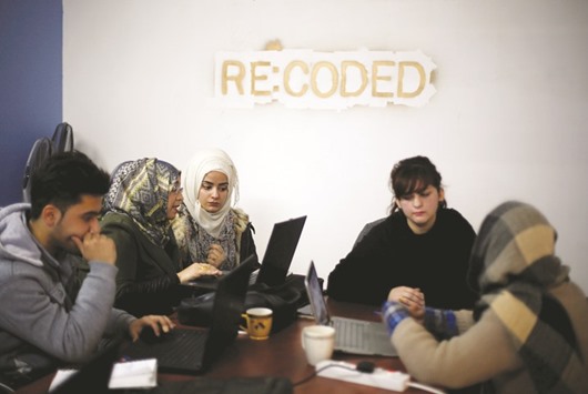 Syrian refugees and displaced Iraqis attend a class on basic and advanced coding skills at the Re:Coded boot camp, in Erbil.
