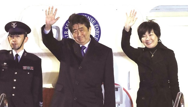 Japanu2019s Prime Minister Shinzo Abe and his wife Akie wave to people seeing them off from the government plane before leaving Haneda Airpot in Tokyo for Washington DC yesterday.