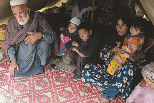 Afghan refugee Gul Pari (second right) sits with her family in a tent on the outskirts of Jalalabad.