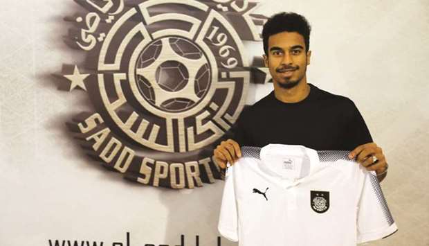 Akram Afif poses with Al Sadd jersey after signing for the QNB Stars League team.