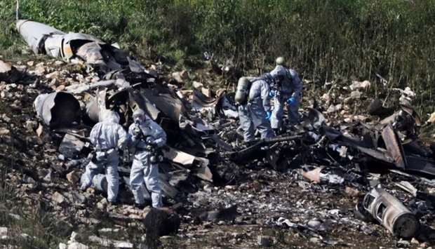 Israeli security forces examine the remains of an F-16 Israeli war plane near the village of Harduf, Israel.
