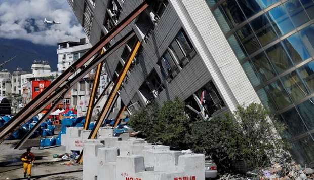A rescuer rushes to a collapsed building after an earthquake hit Hualien, Taiwan