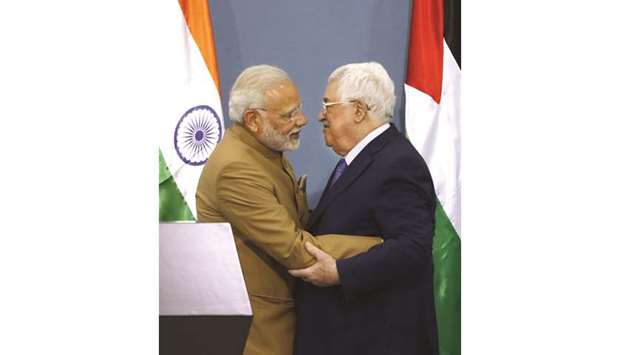 Palestinian President Mahmoud Abbas and Prime Minister Narendra Modi embrace after their joint press conference following their meeting in the West Bank city of Ramallah yesterday.