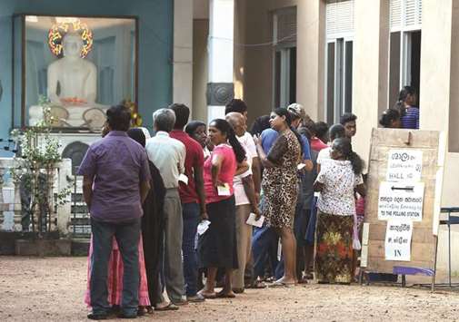 Sri Lankans queue up to cast their vote in the countryu2019s election at a polling station in Colombo yesterday.