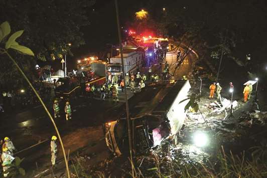 Rescuers work at the site of a crashed bus in Hong Kong, yesterday.