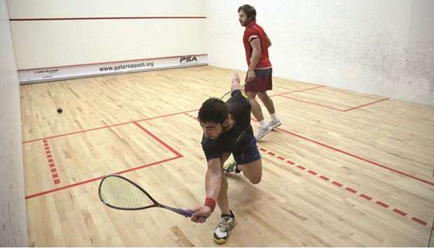Iranu2019s Soheil Shameli (foreground) returns during the Qatar Circuit No 6 Squash Tournament match against Kuwaitu2019s Abdullah al-Muzayen at Khalifa International Tennis and Squash Complex yesterday.