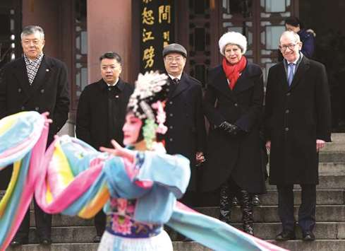 Prime Minister Theresa May and her husband Philip watch a cultural performance at the Yellow Crane Tower in Wuhan, Hubei province, China, yesterday.