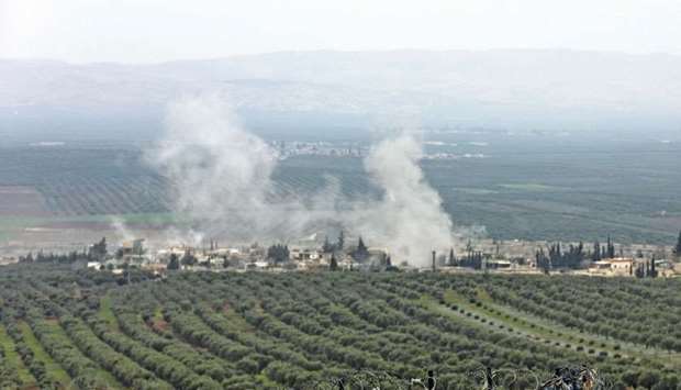 A picture taken yesterday from the Syrian village of Atme in the northwestern   province of Idlib shows smoke plumes rising in the village of Deir Ballut in the Afrin region, where Turkish forces and allied Syrian rebel groups are conducting an offensive.