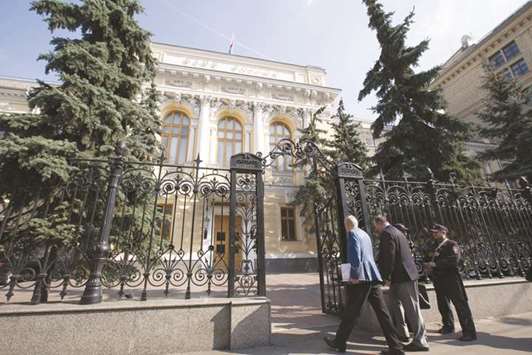Visitors pass security to enter the headquarters of Russiau2019s central bank in Moscow (file). The Bank of Russia is refocusing its sights on trying to support economic growth after inflation settled at the lowest level in the countryu2019s modern history and geopolitical risks receded.
