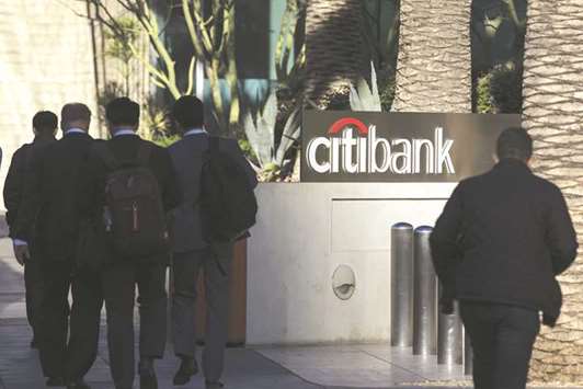 Pedestrians pass in front of a signage outside a Citigroup bank branch in Los Angeles, California. Citigroup is gearing up for a record year of deals from Africa in 2018.