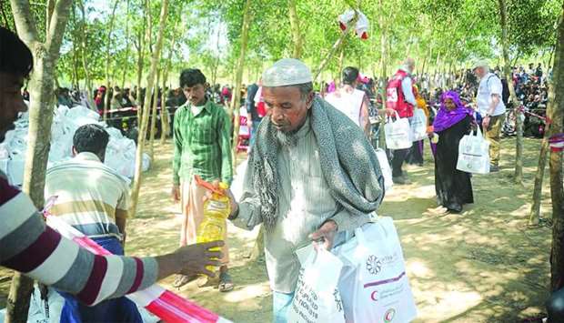 Rohingya refugees receiving aid provided by QRCS and QFFD in Cox's Bazar, Bangladesh.