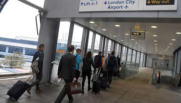 Passengers alight from a train to enter City Airport in London. File photo - October 18, 2017