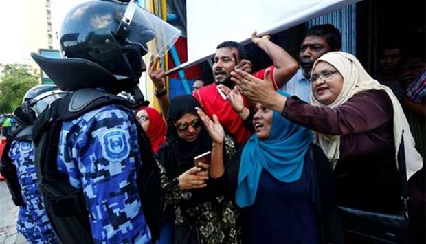 Maldivian opposition supporters argue with a police officer near the Maldives Democratic Party headquarters  in Male last week.