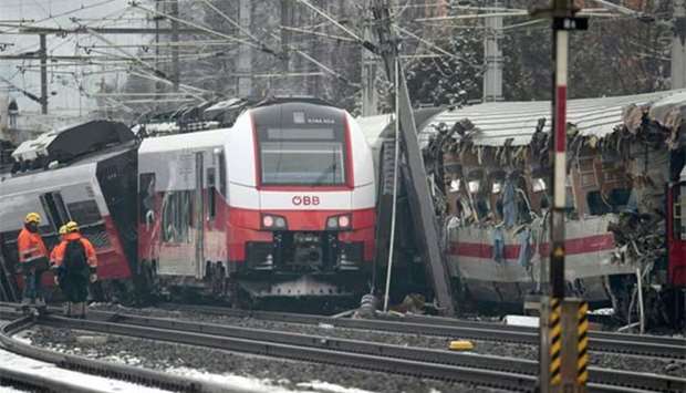 Rescuers are seen at the site where two passenger trains collided in Niklasdorf, central Austria on Monday.