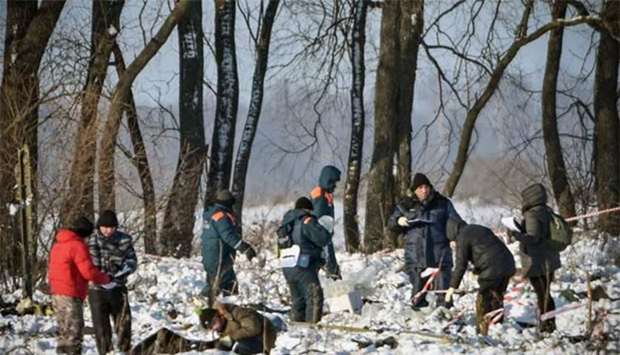 Russian rescuers work at the site of a plane crash in Ramensky district, on the outskirts of Moscow on Monday.