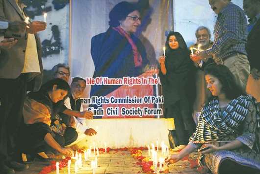People light candles for the human rights campaigner Asma Jahangir, who died on Sunday in Lahore, during candlelight vigil in Karachi, yesterday.