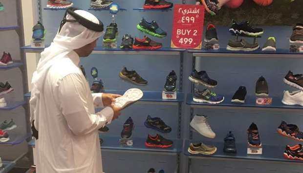 An official of the Ministry of Economy and Commerce inspecting a sports goods store.