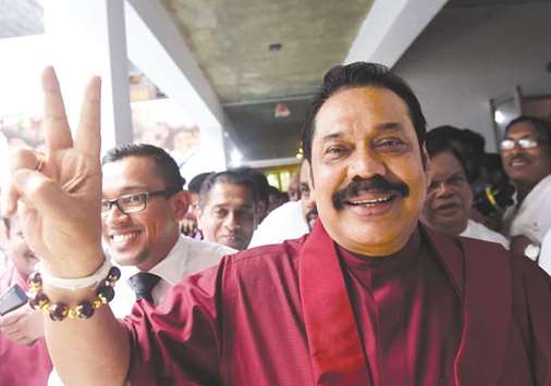 Mahinda Rajapakse waves to supporters at the party office following a press conference in Colombo yesterday.