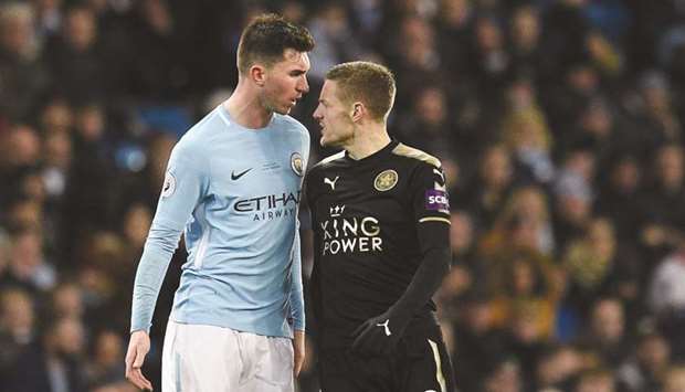 Manchester Cityu2019s French defender Aymeric Laporte (left) clashes with Leicester Cityu2019s English striker Jamie Vardy during their EPL match at the Etihad Stadium in Manchester on Saturday. (AFP)