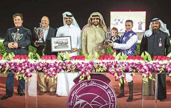 Qatar Racing and Equestrian Club (QREC) general manager Nasser Sherida al-Kaabi with the winners of the Thoroughbred Trophy Trial after Al Shahania Studu2019s Barwod won the 2200m race at the QREC yesterday. PICTURE: Juhaim
