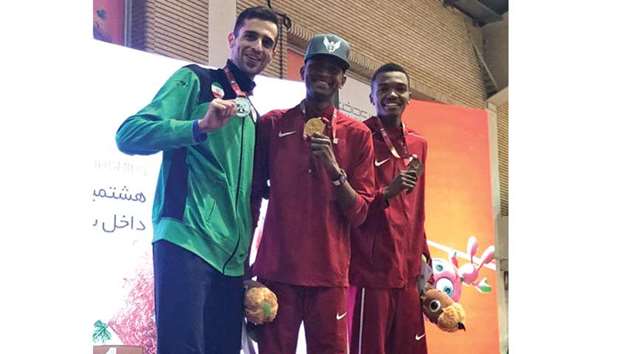 Mutaz Barshim (C) celebrates on the podium in Tehran along with compatriot  Hamdi Amin (R) who won the bronze.