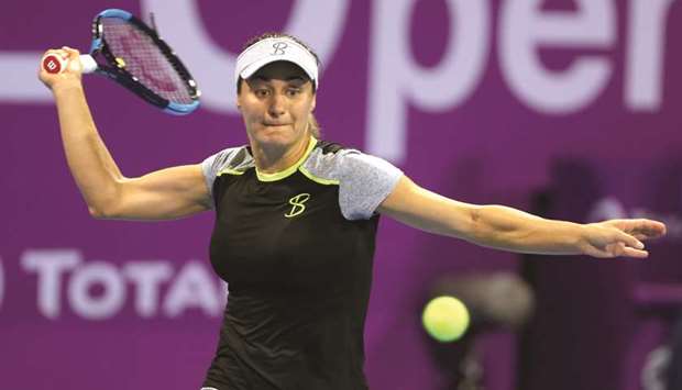 Monica Niculescu of Romania plays a shot against Russiau2019s Maria Sharapova (right) during their first round singles match in the Qatar Total Open at the Khalifa International Tennis and Squash Complex yesterday. PICTURES: Jayan Orma