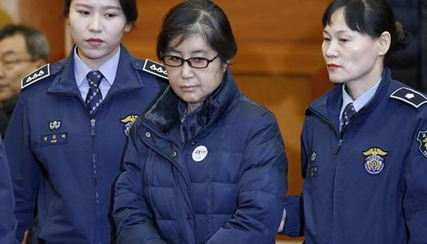This file photo taken on January 16, 2017 shows Choi Soon-sil (C), the woman at the centre of the South Korean political scandal and long-time friend of President Park Geun-hye, arriving for hearing arguments for South Korean President Park Geun-hye's impeachment trial at the Constitutional Court in Seoul