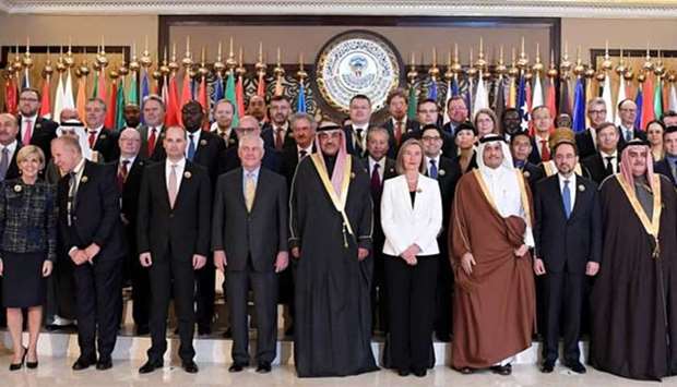 Kuwaiti Foreign Minister Sheikh Sabah al-Khaled al-Sabah is seen with US Secretary of State Rex Tillerson, EU Foreign Policy Chief Frederica Mogherini, HE the Deputy Prime Minister and Foreign Minister Sheikh Mohamed bin Abdulrahman al-Thani. and other dignitaries pose with officials during a ministerial meeting of member states of the US-led military coalition that has been battling the Islamic State in Iraq and Syria, in Kuwait City on Tuesday.