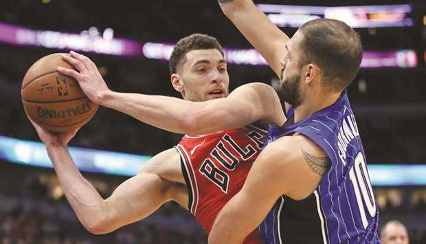 Zach LaVine (left) of the Chicago Bulls is pressured by Evan Fournier of the Orlando Magic during their NBA game at the United Centre in Chicago, Illinois. (AFP)