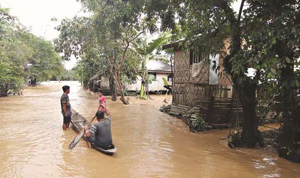 Residents use a canoe to survey their village.