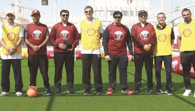 Officials and participants pose at the National Sport Day celebrations at Katara yesterday. At right, kids in action.