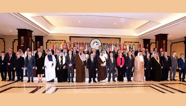 Kuwaiti Foreign Minister Sheikh Sabah al-Khaled al-Sabah (C) stands next to Iraq Prime Minister Haider al-Abadi, EU Foreign Policy Chief Frederica Mogherini, UN Secretary General Antonio Guterres as they pose with other officials for a group photo on the second day of an international conference for reconstruction of Iraq, in Kuwait City.